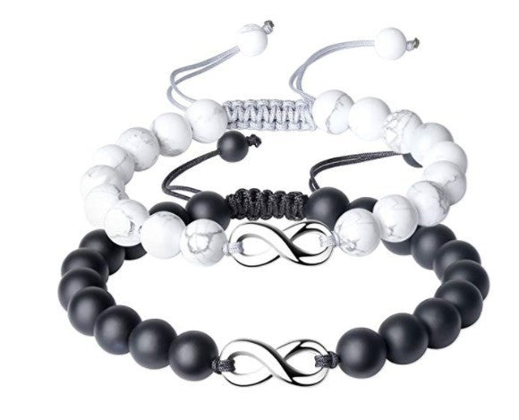 Set of three beaded bracelets with infinity symbols on a white background