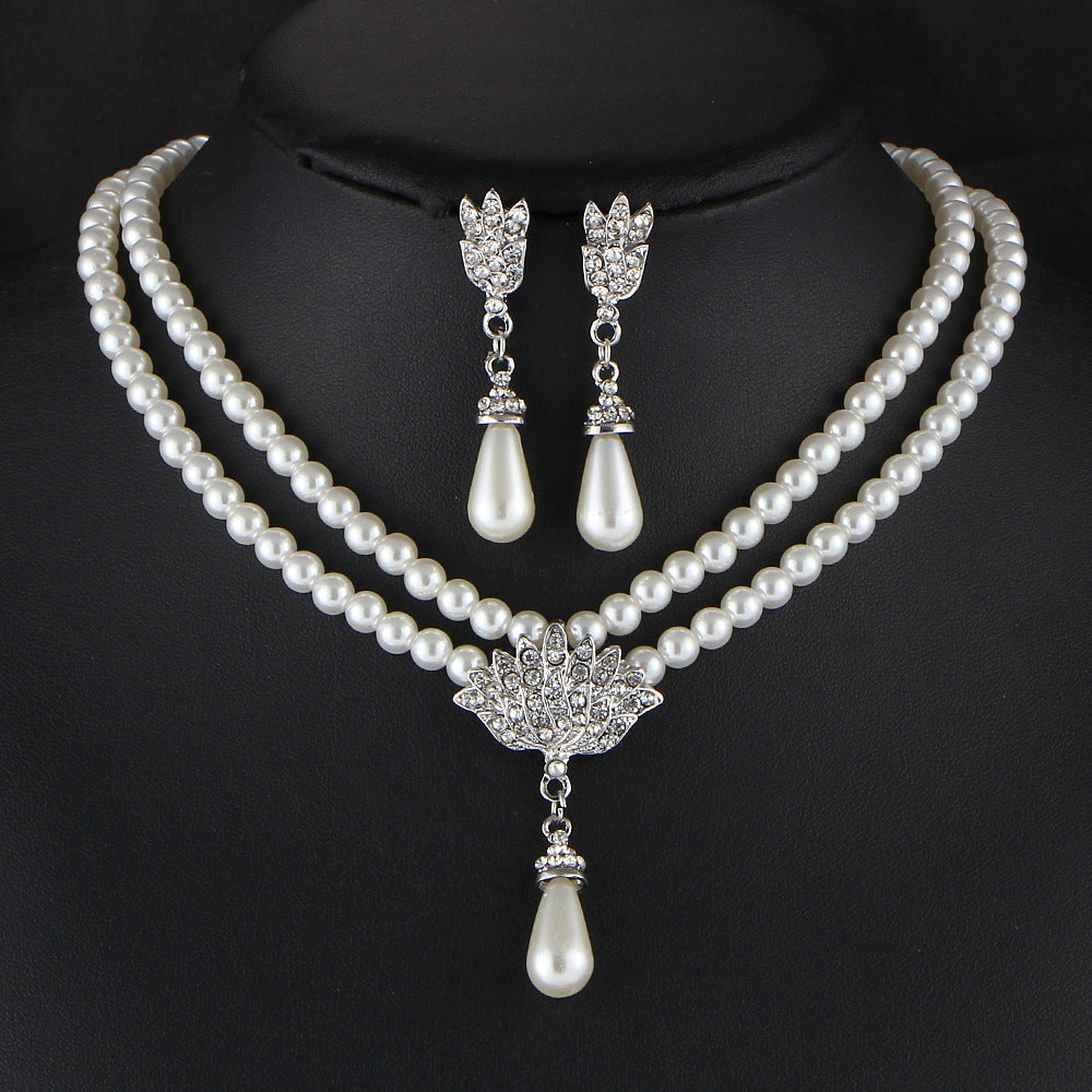 Pearl necklace with matching earrings on a black background