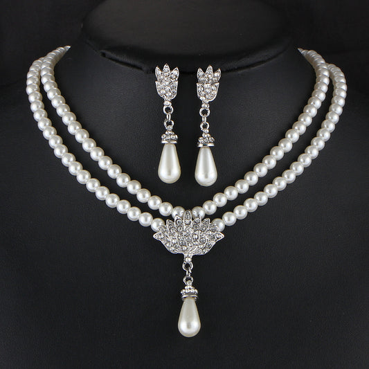 Pearl necklace with matching earrings on a black background