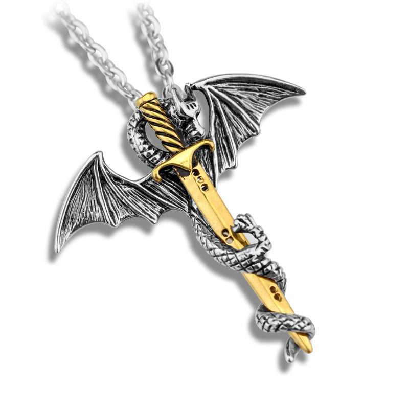 Dragon-shaped pendant with gold and silver design on a white background