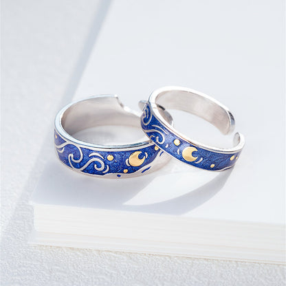 Silver rings with blue and gold designs on a white background