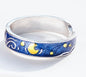 Silver ring with blue band featuring starry night design on a white background